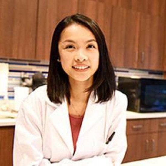 Tina Lai smiling in white coat