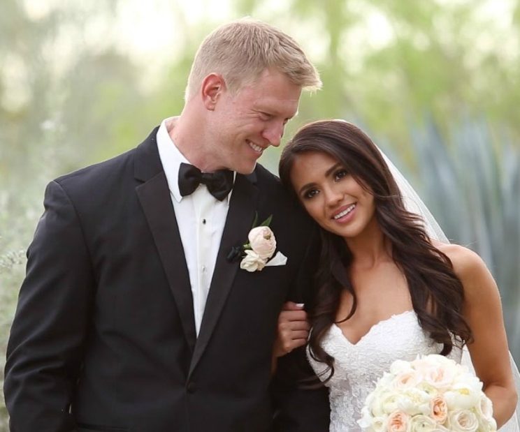 Image of one of the successful football coaches, Scott Frost and his wife