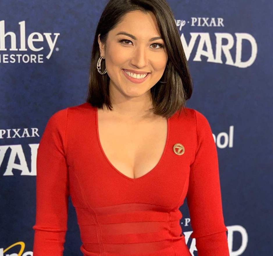 Veronica Miracle smiling in red dress