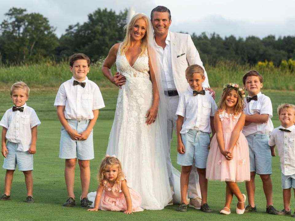 Jennifer Rauchet in white dress with her husband and kids