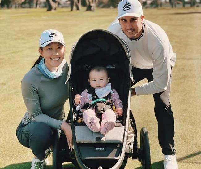 Jonnie West looking happy with his baby girl and wife, Michelle