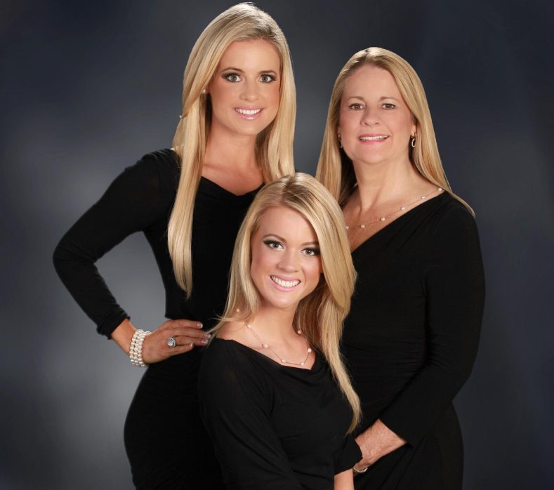 Lisa Thomson in black outfit with her sister, Michelle and mother